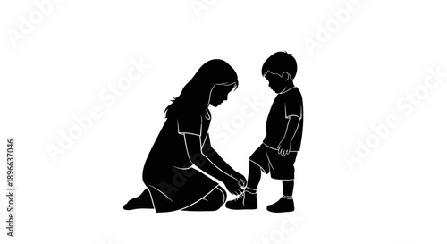 Mother helping young son to put on his shoes.