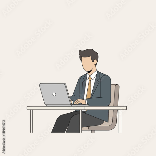 Businessman working on laptop at desk in minimalist office setting