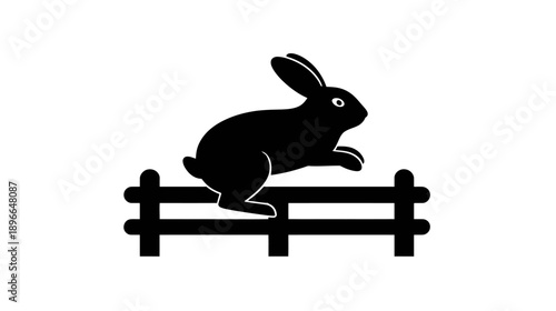A black bunny jumping over a fence against a white background. Silhouette illustration