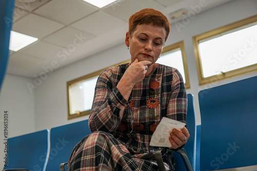 Woman consulting receptionist in medical clinic, waiting for appointment and healthcare service