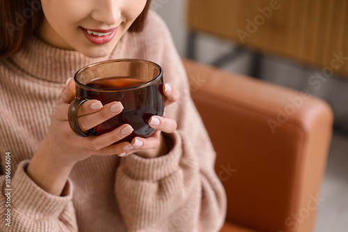 Young woman with glass cup ...