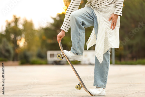 Young man riding skateboard...