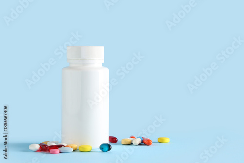 Bottle with pills on light ...