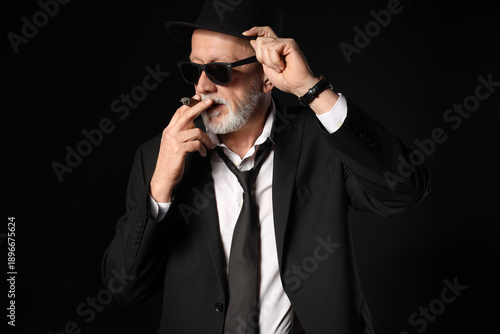 Old businessman smoking cig...