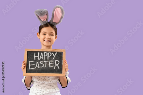 Cute girl in bunny ears hol...
