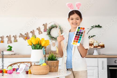 Cute girl with paints and b...