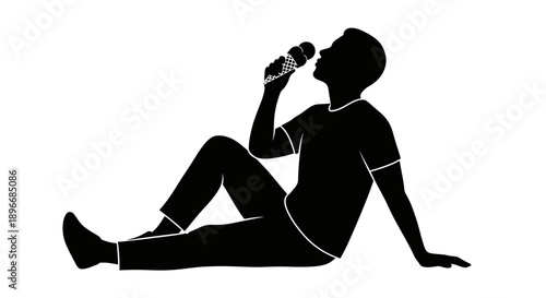 Silhouette of a person sitting on the floor and singing into a microphone