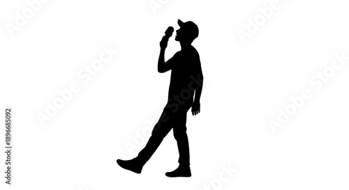 Dynamic silhouette of an energetic male performer passionately singing into a microphone while walking, capturing the essence of a live vocal act or creative expression