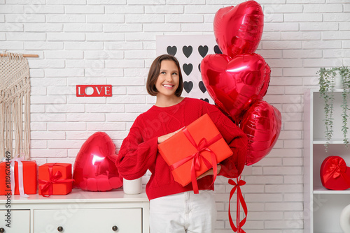 Happy young woman with gift...