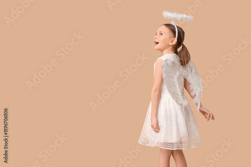 Cute little girl dressed as...