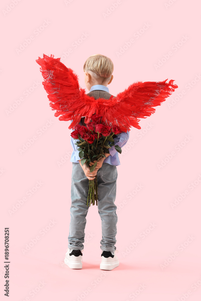 Obraz premium Cute little boy in cupid wings with bouquet of beautiful roses on pink background, back view. Valentine's Day celebration