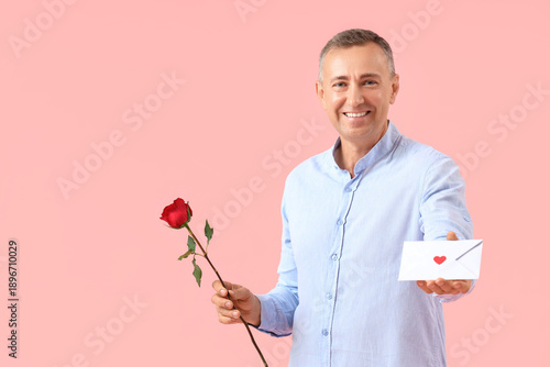 Happy mature man with rose ...