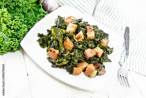 Kale cabbage with bacon in plate on white board