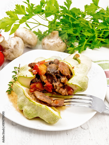 Patisson stuffed with liver and mushrooms in plate on light board