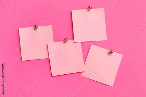 Paper notes pinned on pink ...