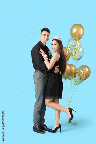 Young prom couple with ball...