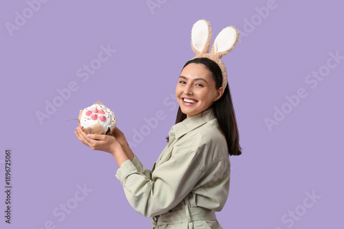 Happy young woman in bunny ...