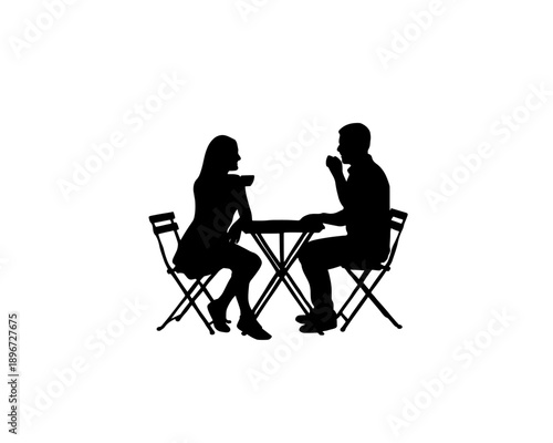 Silhouette of two people sharing a conversation over a meal at an outdoor setting