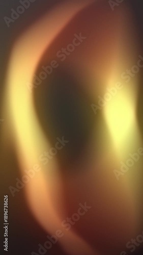 Soft abstract light glows in fluid golden and orange waves against a dark background, creating an ethereal glow