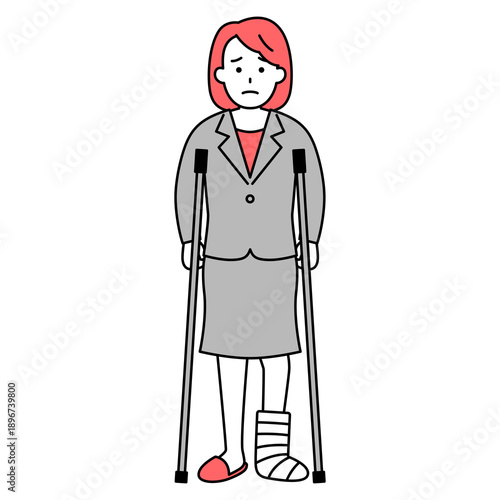 足を怪我して松葉杖をついているスーツの女性