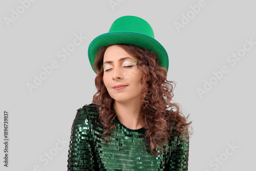 Woman in green hat on light...