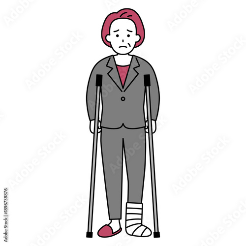 足を怪我して松葉杖をついている中年のスーツの女性