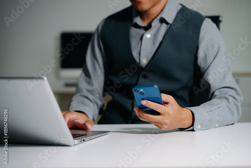 Businessman hand working digital marketing media in virtual screen with mobile phone and modern compute with VR icon diagram at office