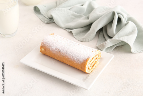 Bild auf Leinwand Plate with sweet sponge cake roll on white background