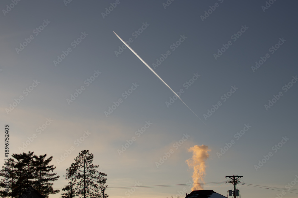 Obraz premium A jet flying high over the city