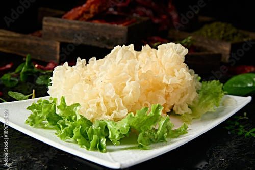 Tableau sur toile Fresh white fungus, a hot pot ingredient, is served on a white porcelain plate