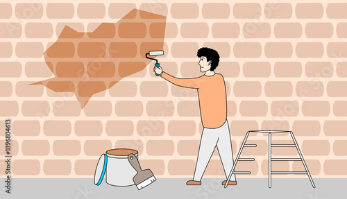 Man is painting a wall with a brush
