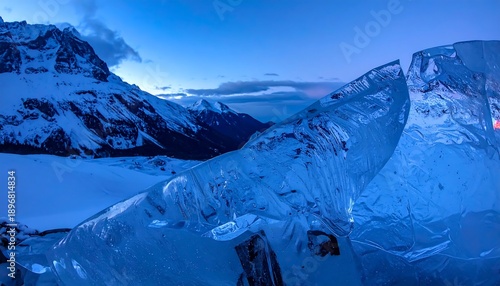 Majestic Ice Formations Against a Dramatic Mountain Landscape at Dusk.
