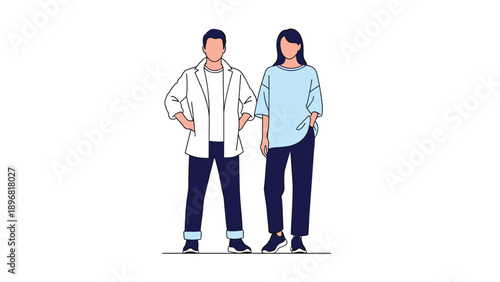Professional couple in smart casual attire stands together confidently with hands on hips against a white backdrop.