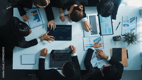 Cuadro en lienzo Top view of smart business people brainstorm marketing idea at meeting table while compare stock market investment data between laptop and tablet