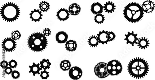 A collection of various black mechanical gears and cogs arranged in a grid pattern on a plain white background viewed from directly above