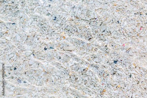 Clear sea water with a sandy bottom and sun glare. Relaxation and tranquility on vacation. Background. Space for text.