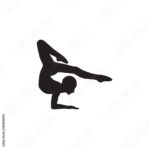 Silhouette of a young woman practicing yoga exercise in a graceful pose