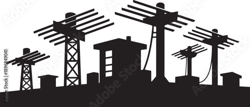 Silhouette of television antennas on a city skyline rooftop