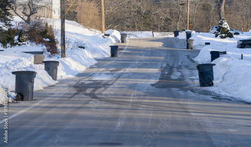 residential street after snow in garbage collection day