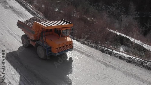 A quarry dump truck transports mined rock