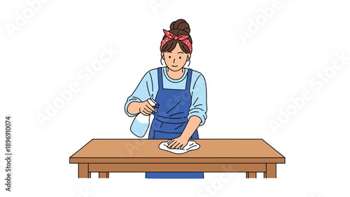 Woman in a blue apron and red bandana spraying a wooden table with disinfectant and wiping it clean with a white cloth.