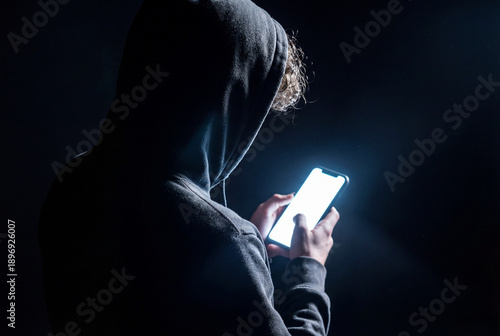 Person Using Smartphone at Night with Dark Moody Lighting Concept