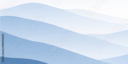 A serene winter nature landscape featuring a misty blue mountain range with snow covered peaks under a clear sky overlooking a foggy forest valley at sunrise