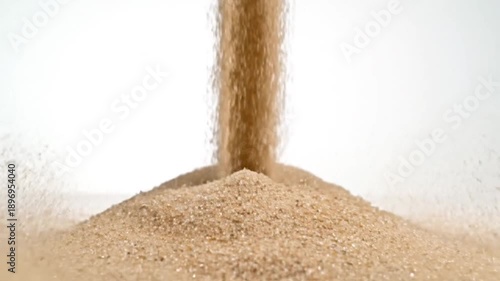 Wallpaper Mural Slow Motion Sand Pouring and Impact, Dynamic Movement of Grains Against White Background Depicting Torontodigital.ca