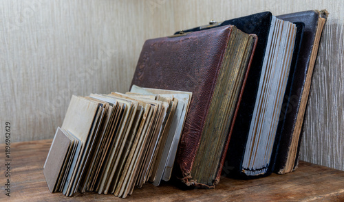 A stack of vintage photo albums on the table.Old photo archives.Family archive.