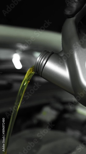 Close-Up of Motor Oil Pouring from Canister into Car Engine