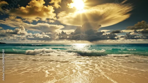 Wallpaper Mural A serene beach scene at sunset, with sun rays shining through clouds over calm ocean waves washing onto a sandy shoreline Torontodigital.ca