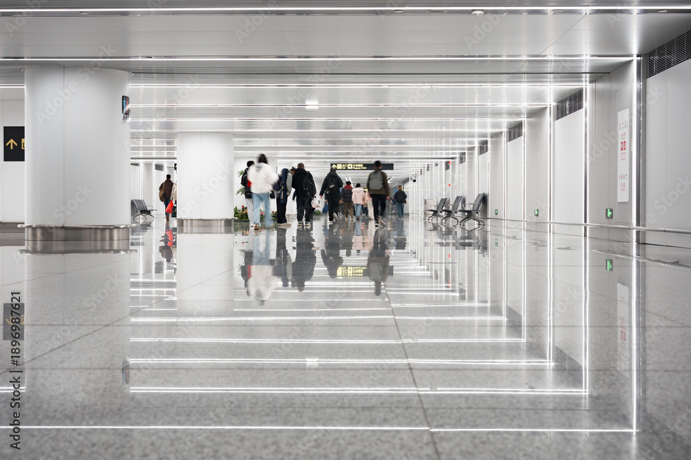 Naklejka premium Pedestrians walking in a modern bright corridor