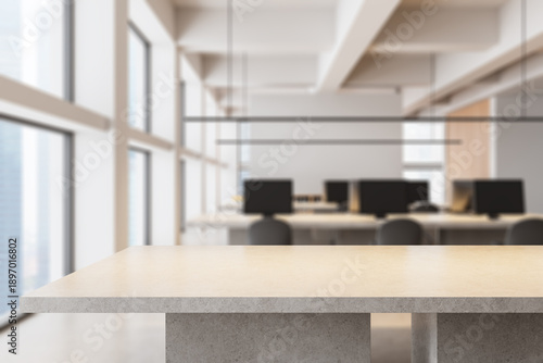 Modern office interior with blurred background and stone counter in foreground emphasizing open workspace design and natural lighting concept. 3D Rendering