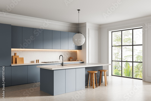 Modern minimalist kitchen interior with blue cabinets, large island, and pendant lighting in bright space with garden background and natural daylight. 3D Rendering